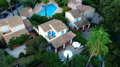 The house from the air: the terrace with its parasols, the pool behind