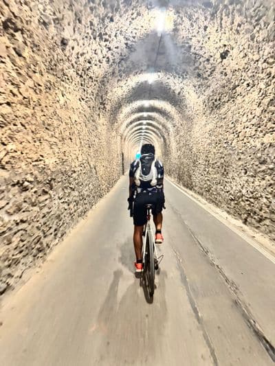 Cyclist in a tunnel on the old railway line towards Toulon